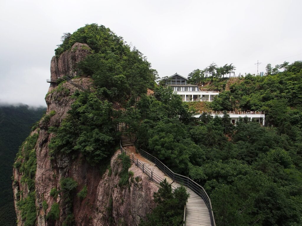 A rhyolite pillar wrapped in forest at Shenxianju scenic area in Xianju, Zhejiang