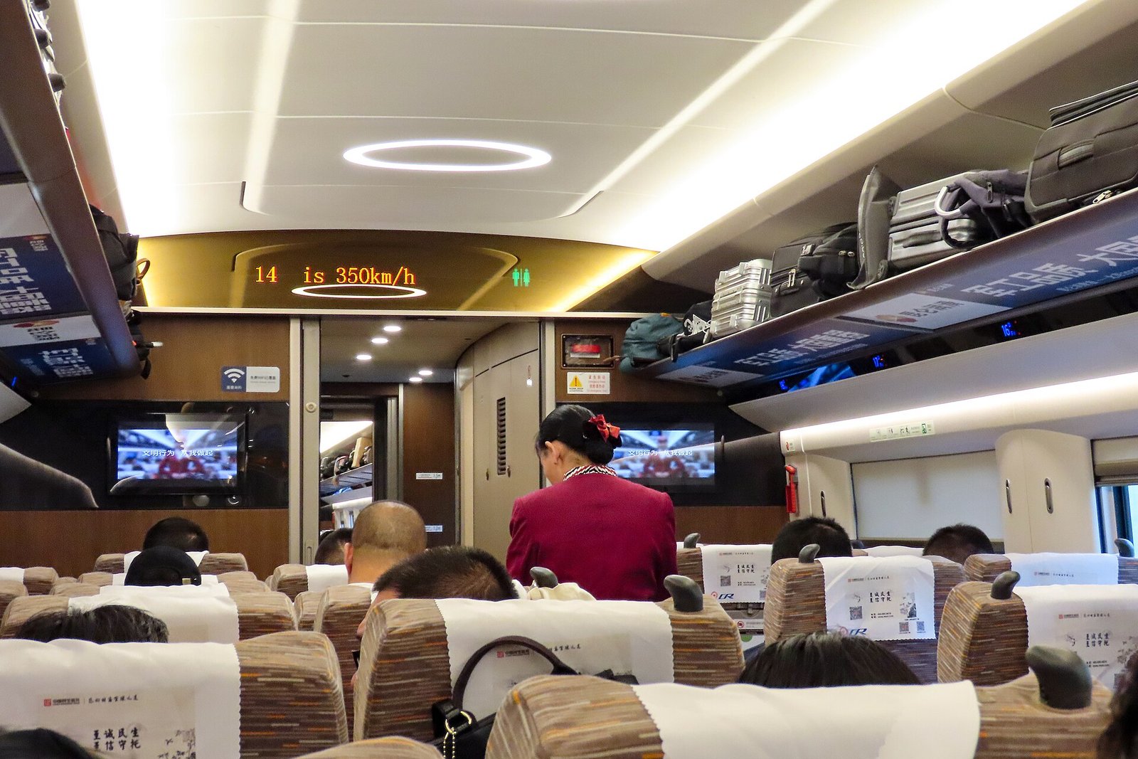 The overhead display inside a China Railway CR400AF high-speed train reading 350 km/h, the speed that makes multi-city C-drama itineraries possible
