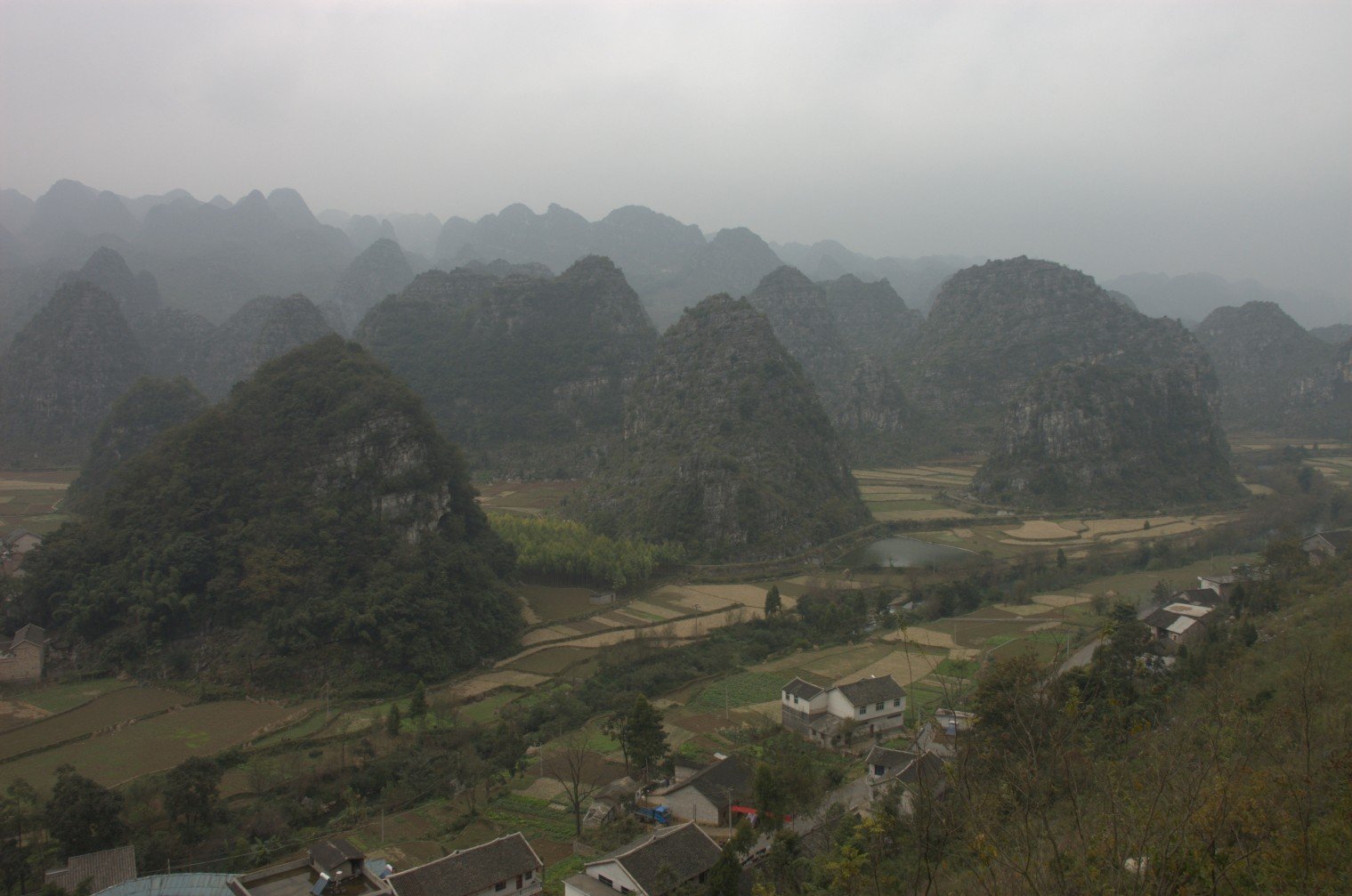The cone-shaped karst peaks of Wanfenglin rising above the fields near Xingyi, Guizhou