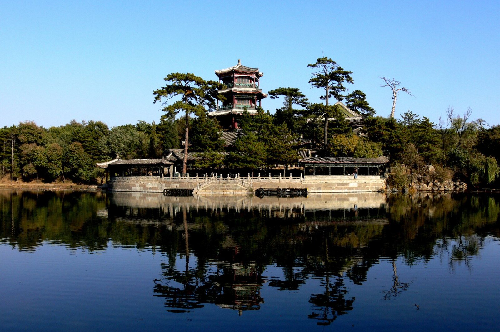 A small island pavilion with rockery at Chengde reflected in still lake water