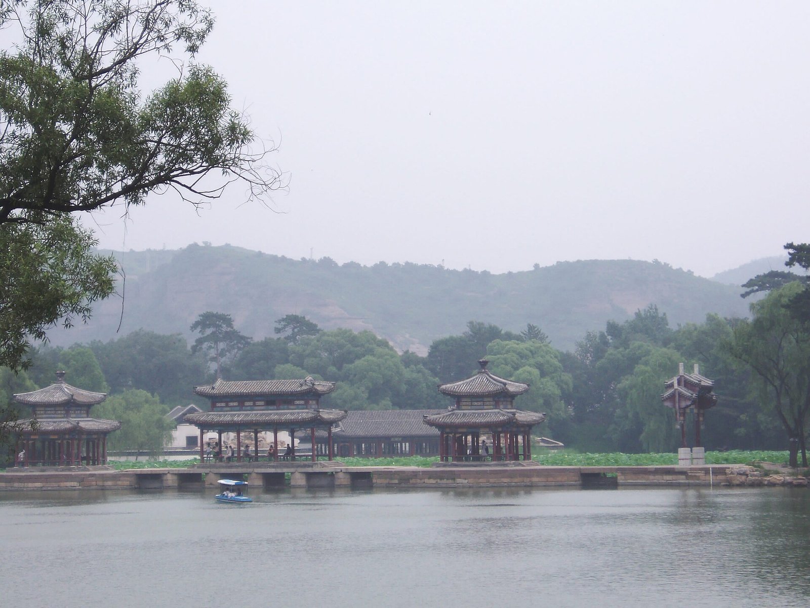 Pavilions and islands in the Chengde Mountain Resort seen across still water in morning mist