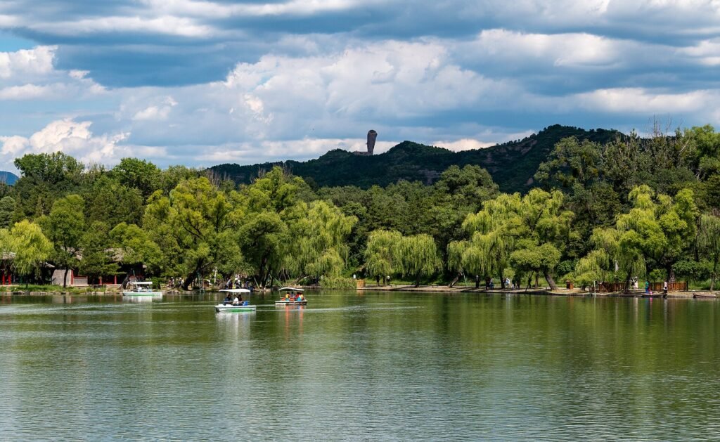 A lake in the Chengde Mountain Resort with wooded islands, pavilions and a ridge of hills behind