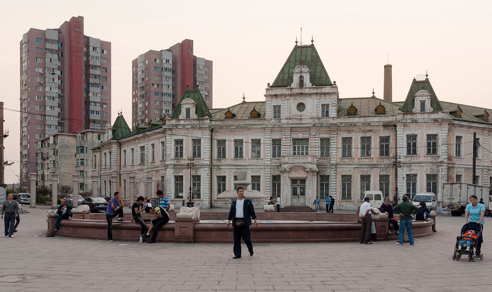 Russian Street in Dalian, a row of pastel European-style facades along a paved plaza with people walking