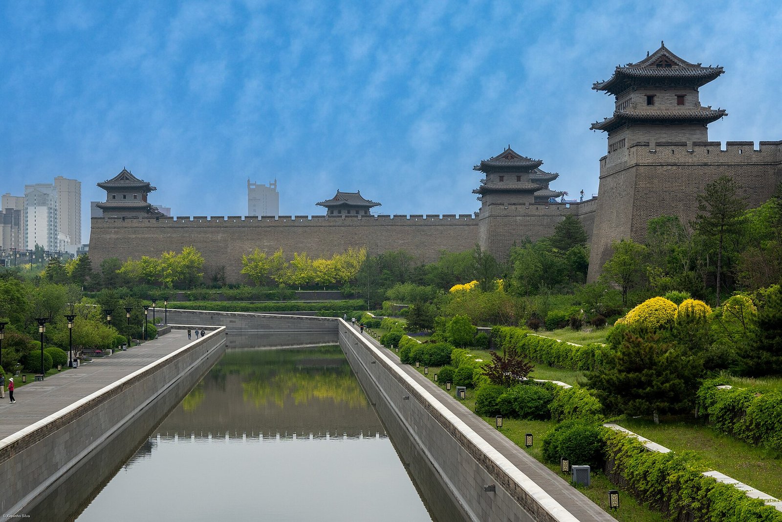 The rebuilt Ming city wall of Datong rising above its moat