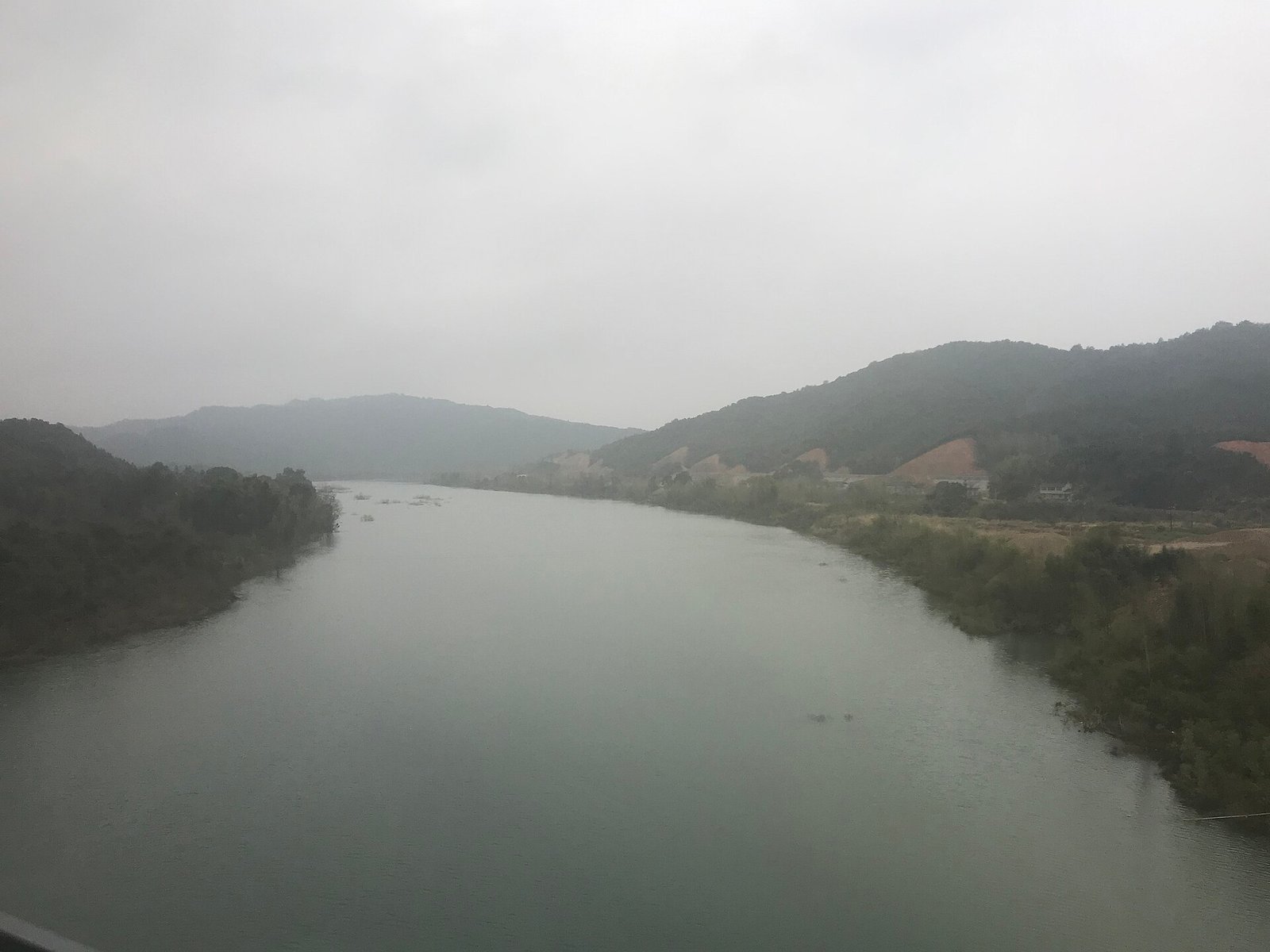 Mist over the Changjiang River at Fuliang in Jiangxi, with wooded hills fading into the distance