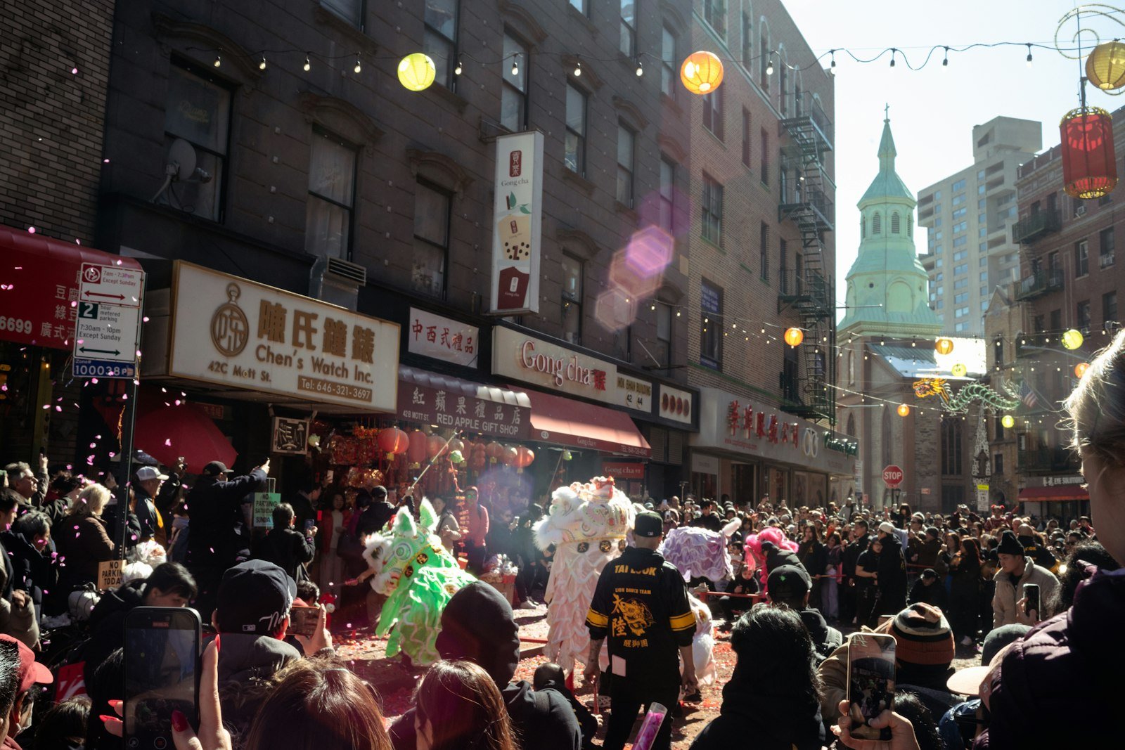 A crowd watching a dragon dance in a Chinese city street celebration