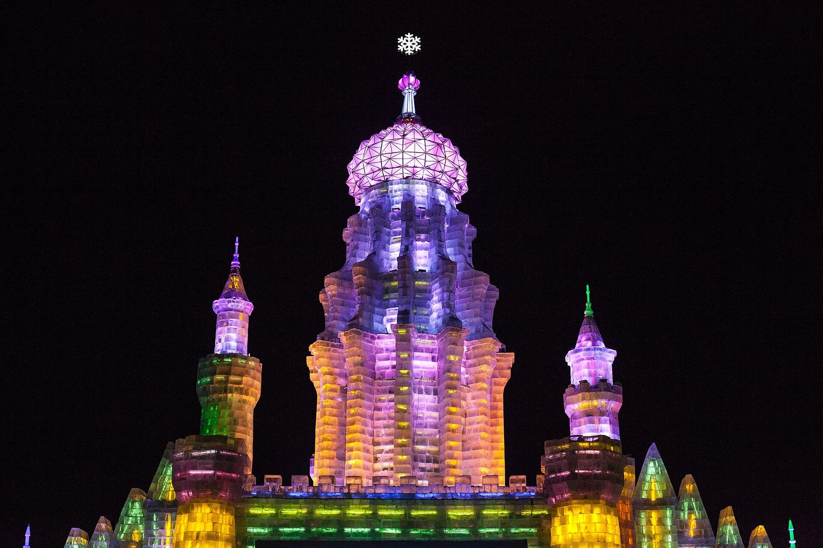 Illuminated ice sculptures at the Harbin Ice and Snow World festival at night
