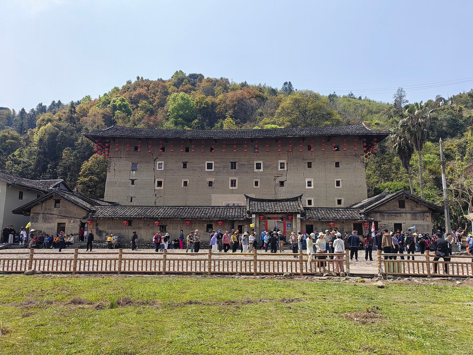 The tall square earthen facade of Hegui Lou at Yunshuiyao, five storeys high, standing beside a paved courtyard