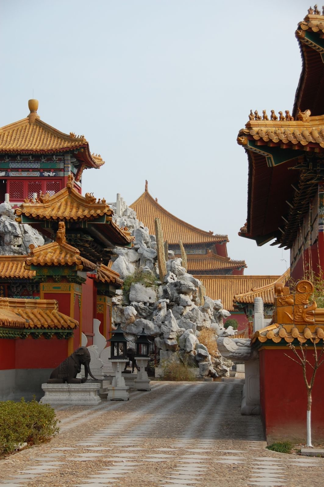 Yellow glazed roofs, red walls and a rockery garden inside the Ming Qing Palace set at Hengdian World Studios