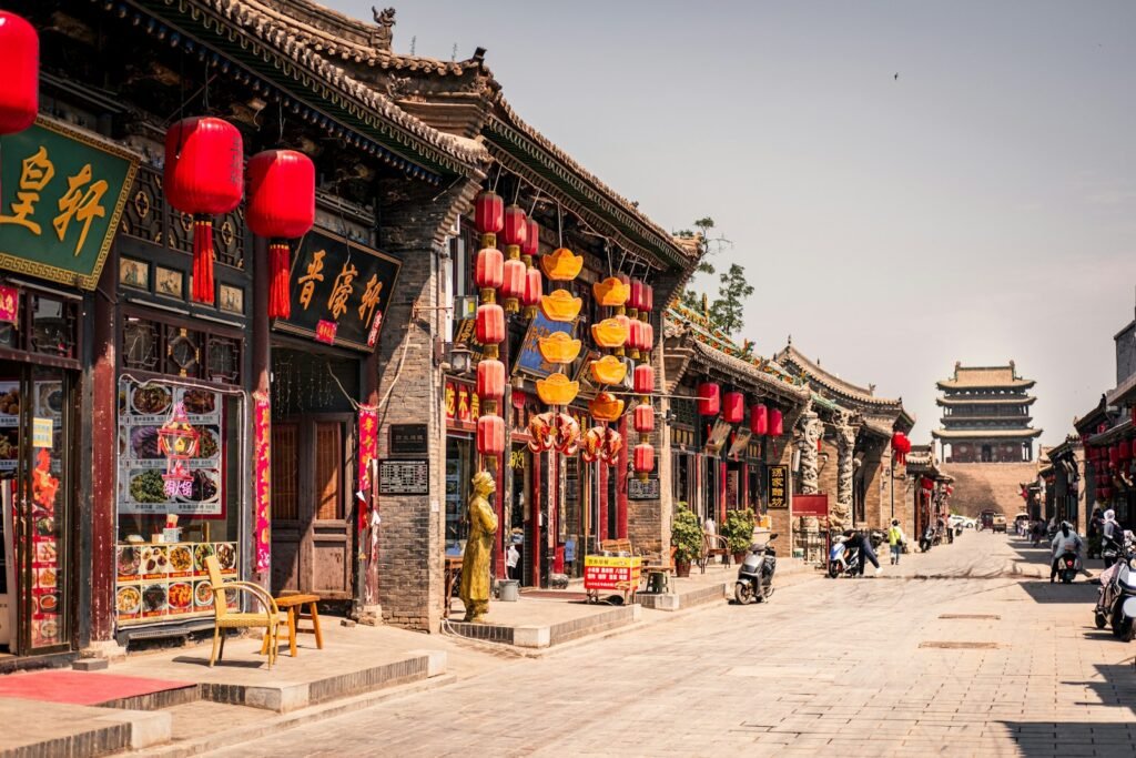 A traditional southern Chinese street of shophouses hung with red lanterns