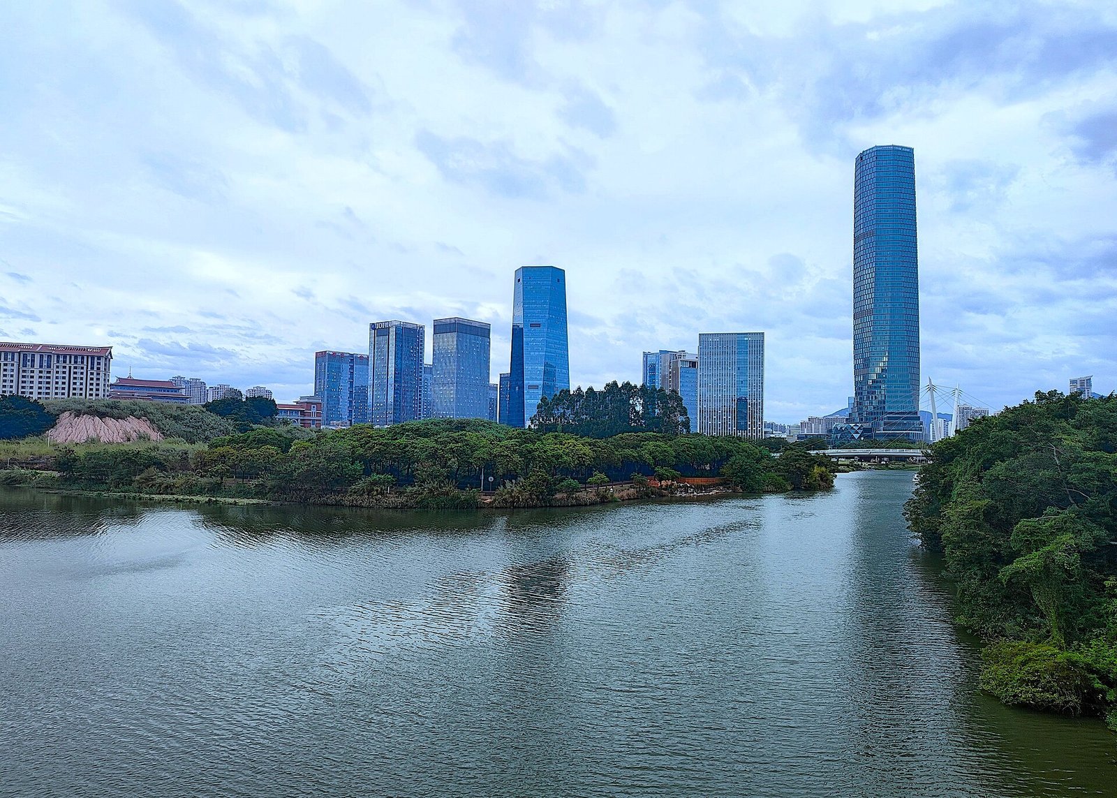 The modern skyline of Jimei new town in Xiamen seen across a river from the Garden Expo Park