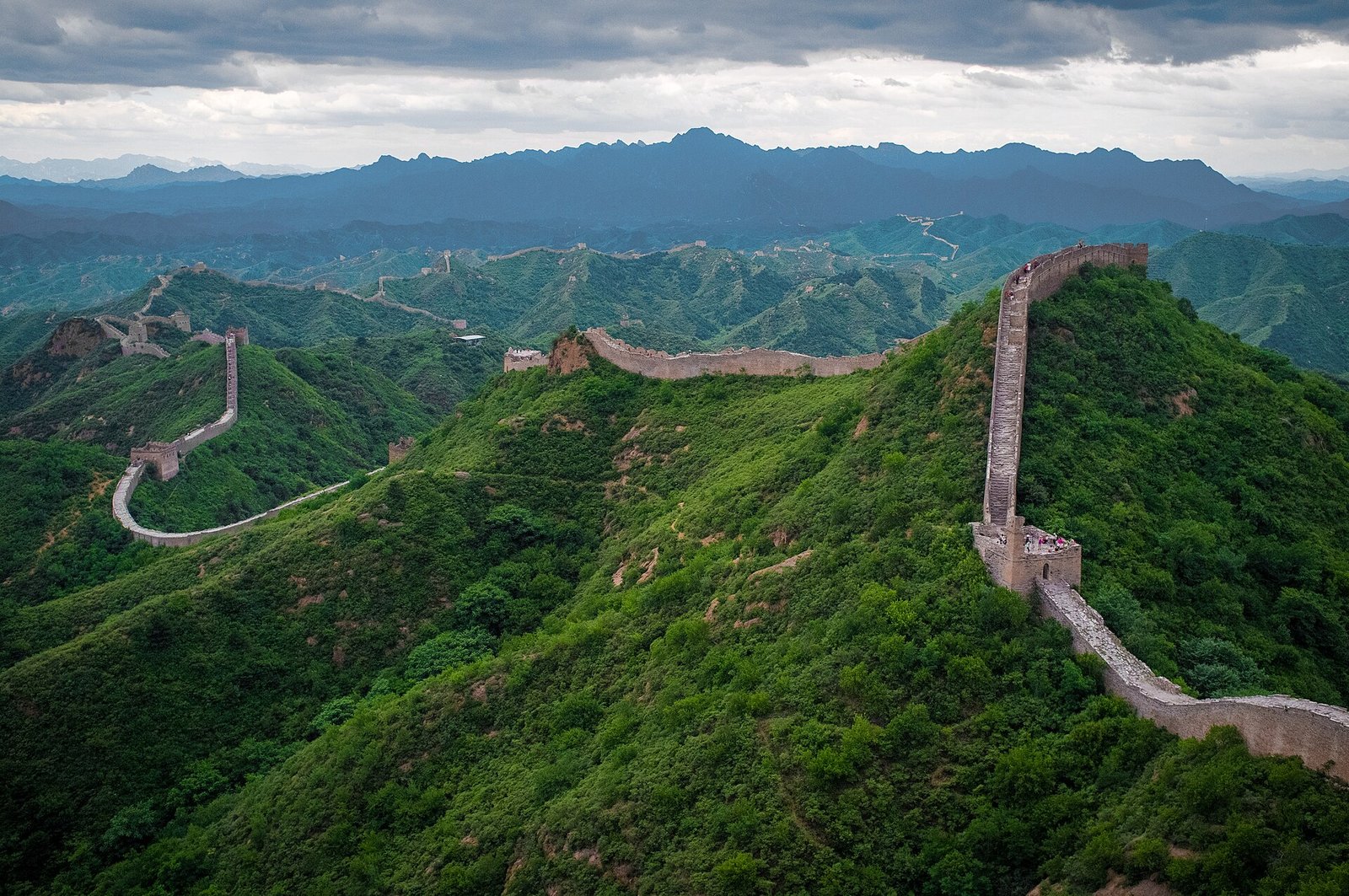 The Great Wall at Jinshanling running along forested ridges with watchtowers at intervals