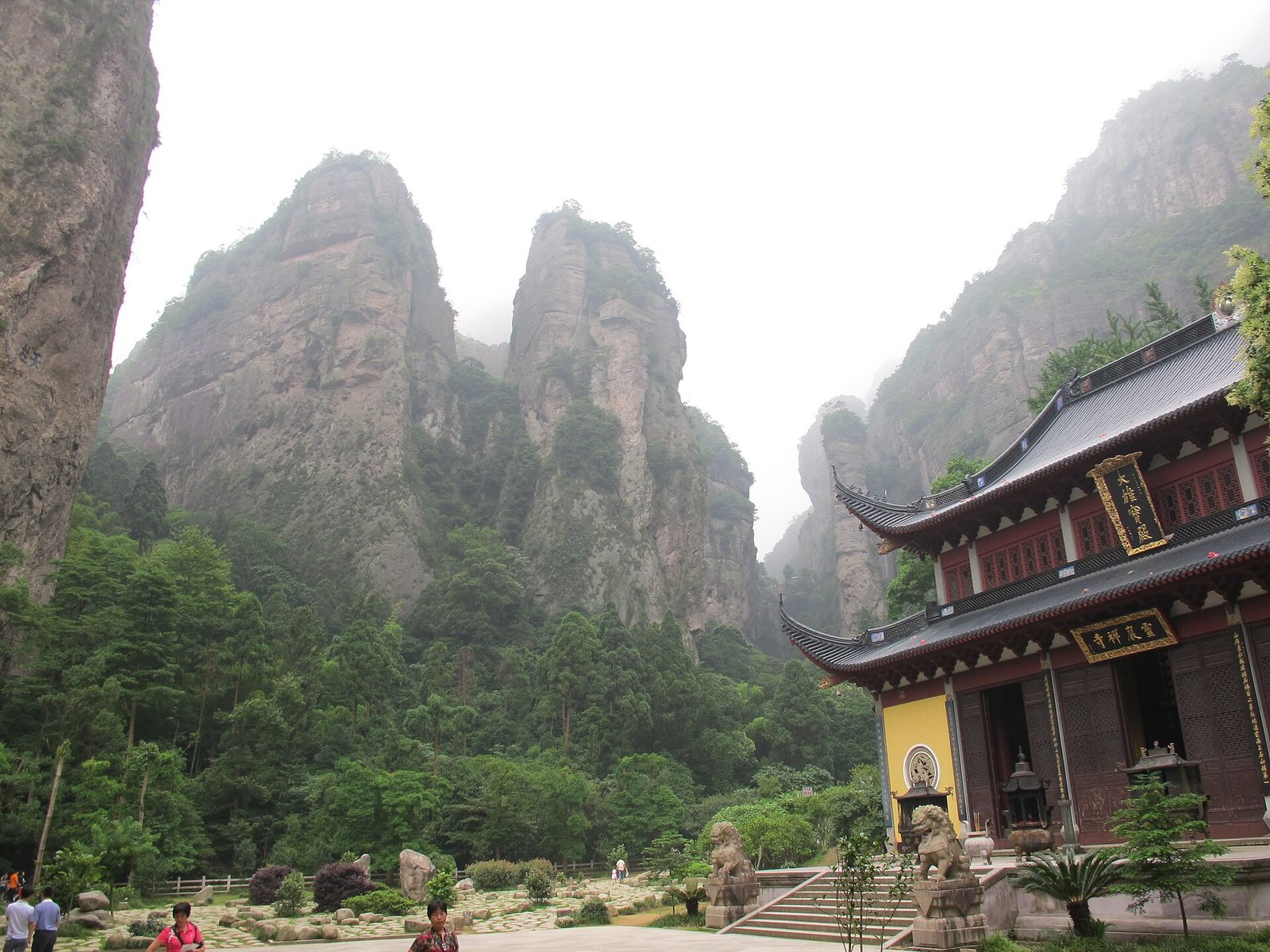 Panorama of the Lingyan scenic area at Yandang Mountain, showing the temple courtyard enclosed by towering cliff walls
