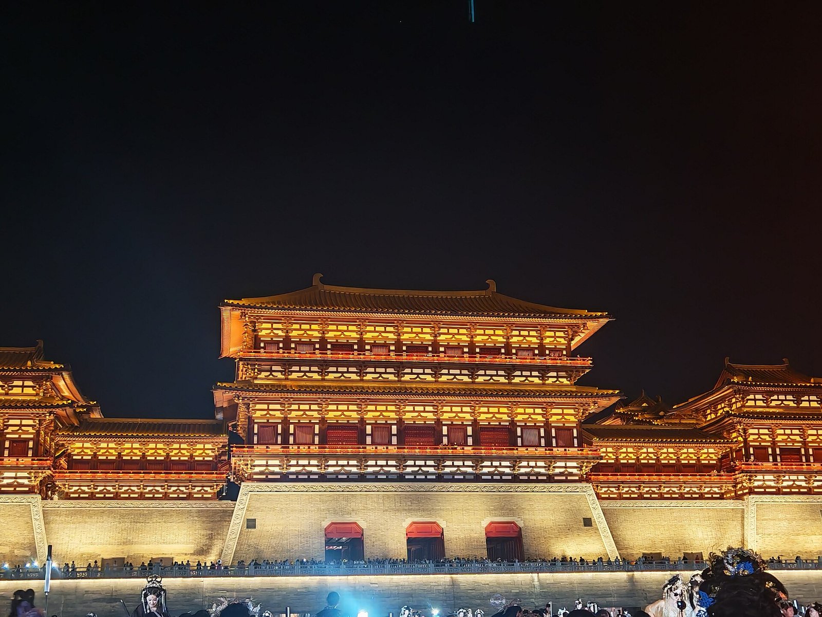 Yingtian Gate in Luoyang lit up at night, its Tang-style towers glowing gold