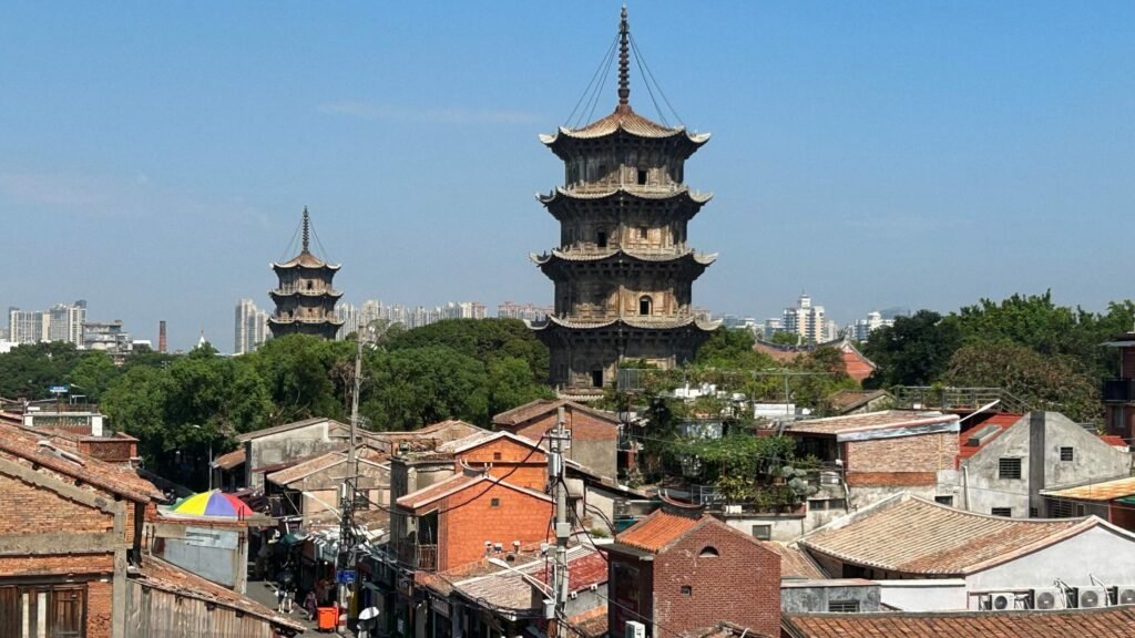 West Street in Quanzhou with the twin stone pagodas of Kaiyuan Temple rising above the low red-brick shops