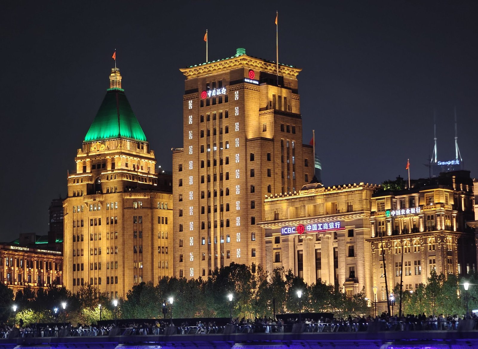 The Bund at blue hour. This 1920s–30s banking frontage is what Blossoms Shanghai dressed as its own.