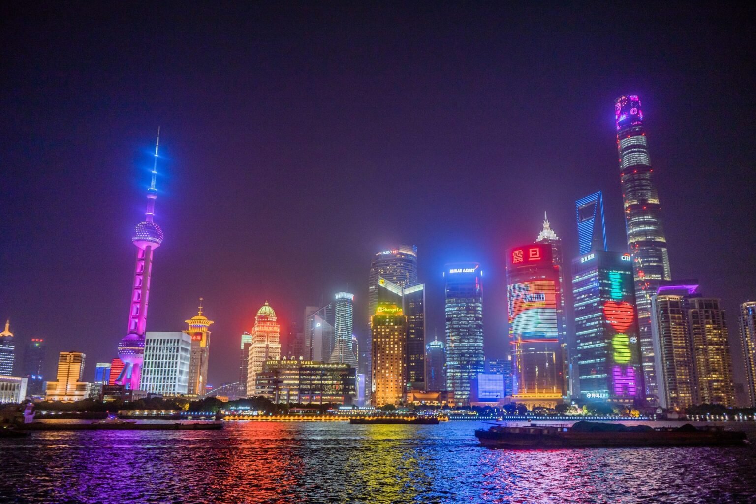 The Lujiazui skyline in Pudong, Shanghai, lit up at night across the Huangpu River