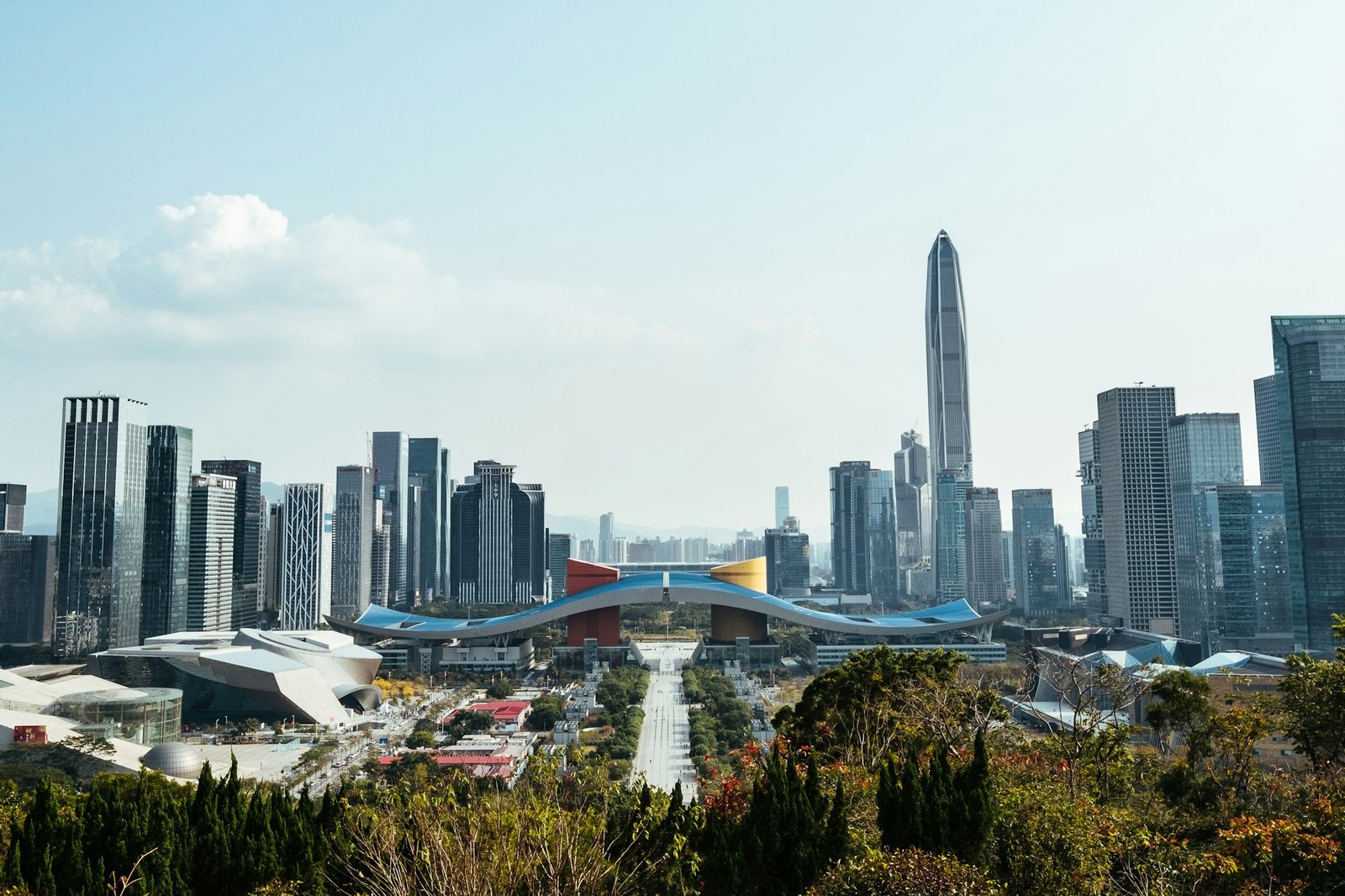 The Shenzhen civic centre skyline in daylight, with the city's tallest tower rising behind the office blocks