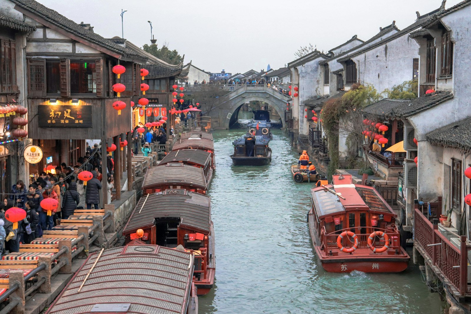 A canal lined with old whitewashed houses and stone bridges in a Chinese water town