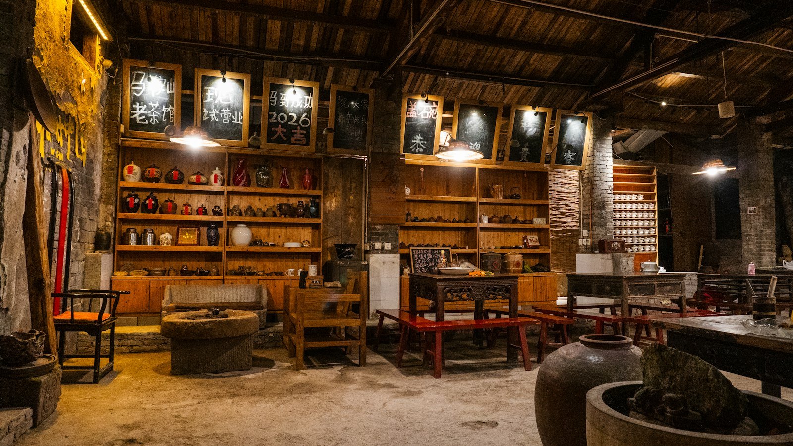 A traditional Chinese teahouse interior with wooden furniture and a teapot on a table