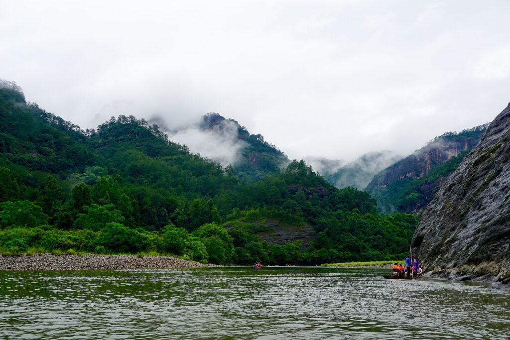 The Nine-Bend Stream at Wuyishan in Fujian, green water between wooded sandstone peaks under low cloud