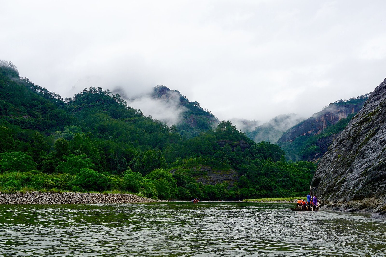 The Nine-Bend Stream at Wuyishan in Fujian, green water between wooded sandstone peaks under low cloud