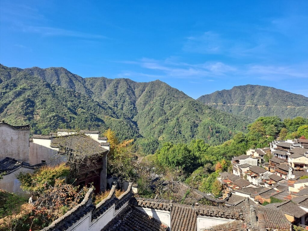 The terraced village of Huangling in Wuyuan, Jiangxi, with whitewashed houses stacked up a wooded hillside