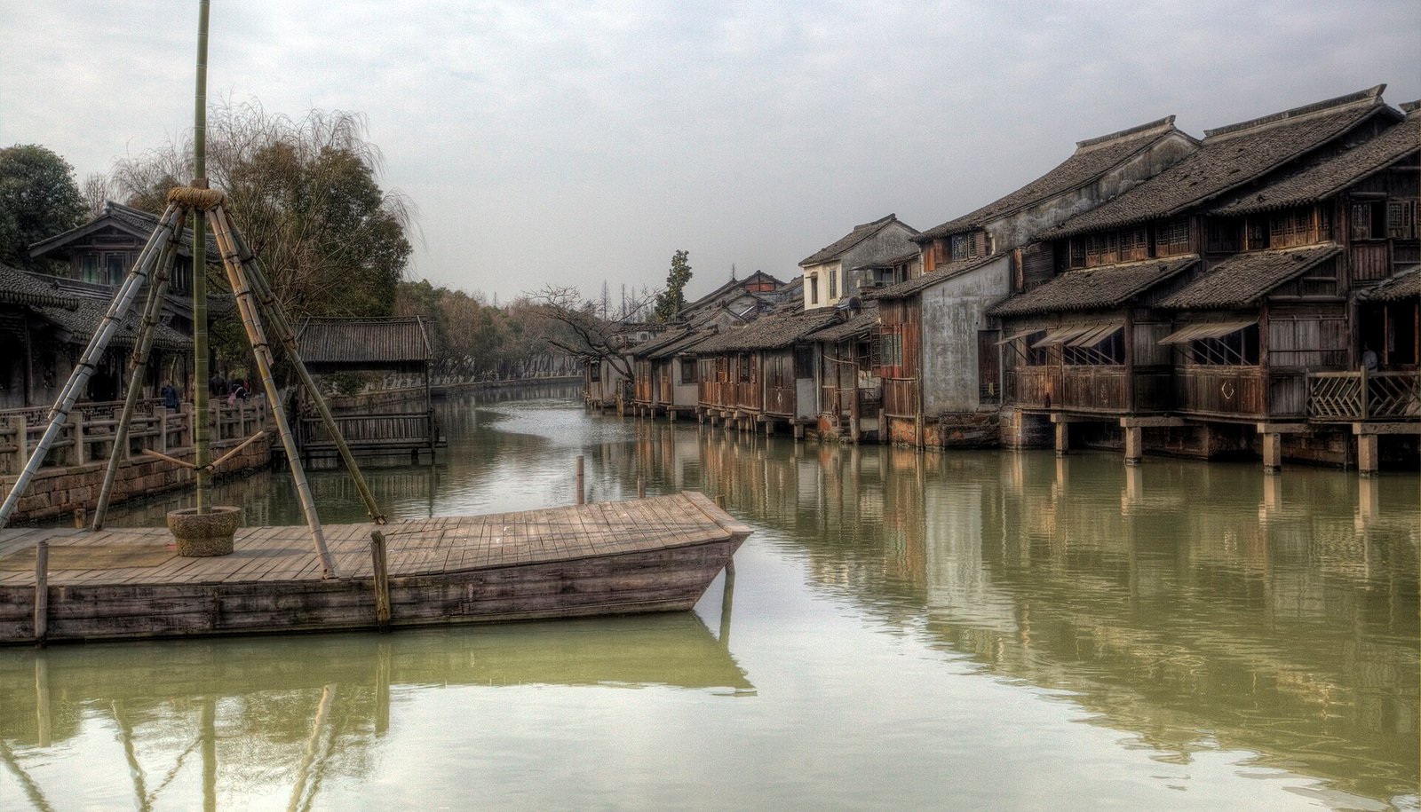 Wuzhen in winter, with bare willows, moored boats and grey water under a pale sky
