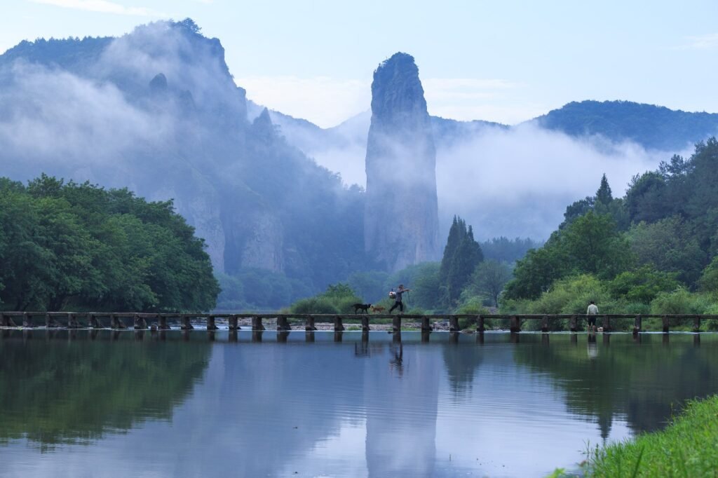 Dinghu Peak rising out of mist above a stone bridge at Xiandu scenic area in Jinyun, Zhejiang