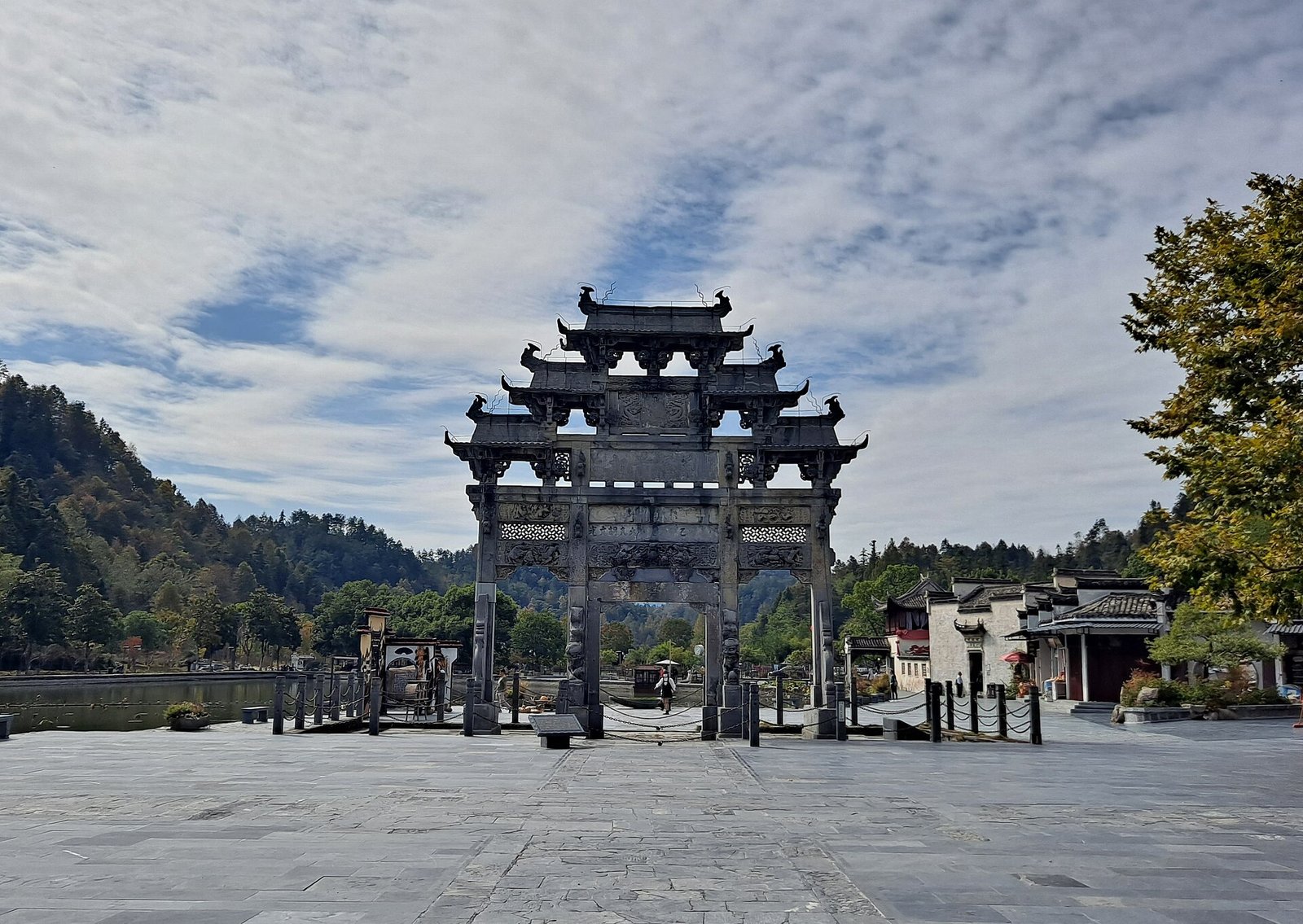 The Hu Wenguang memorial archway, an ornate stone gateway, at the entrance to Xidi village