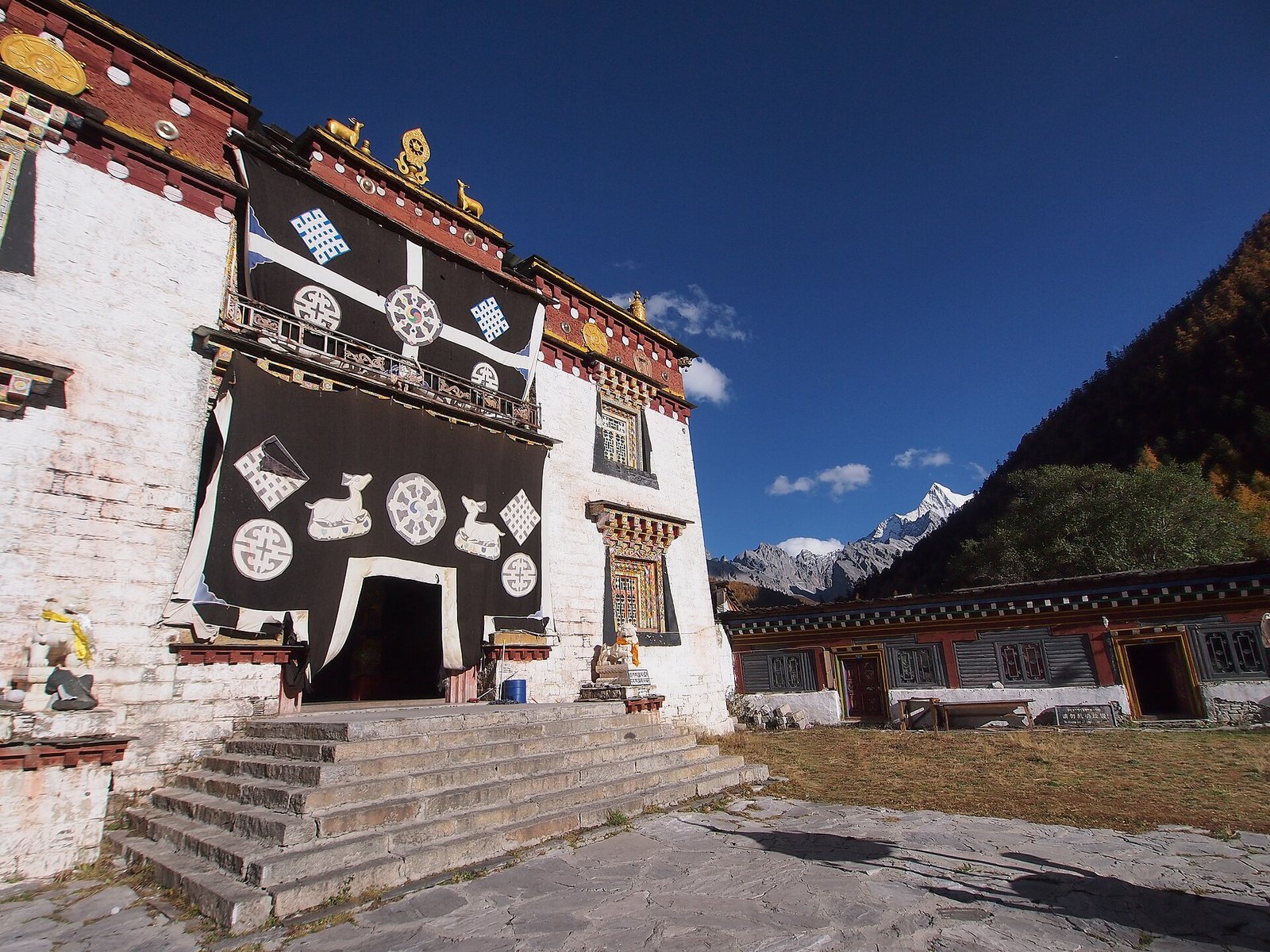 The white walls and dark timber window frames of Chonggu Monastery at Yading