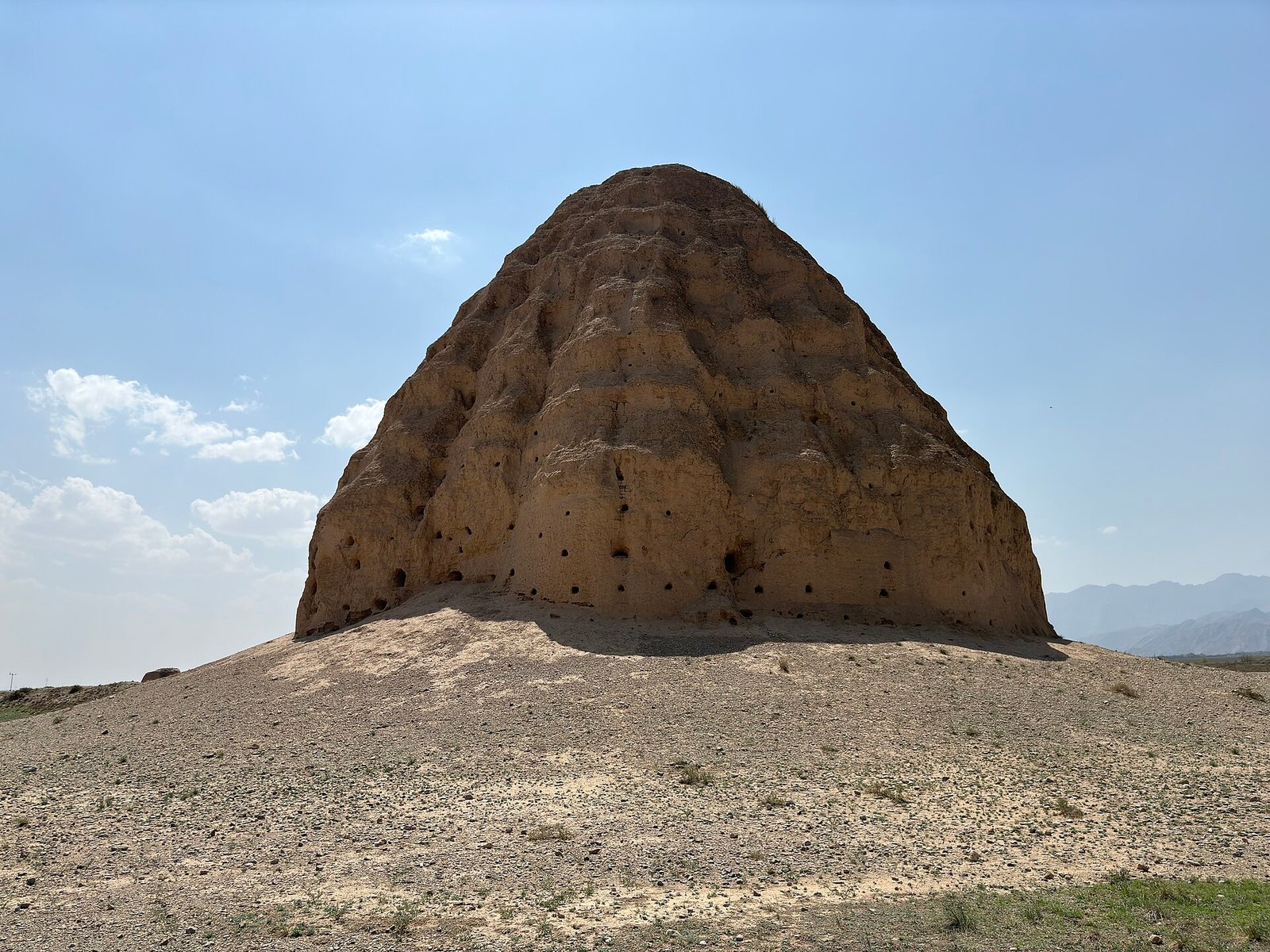 A rammed-earth tomb tower of the Xixia Imperial Tombs on the plain below the Helan Mountains