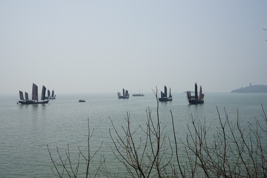 Traditional sailing boats on the misty water of Lake Tai off Yuantouzhu in Wuxi
