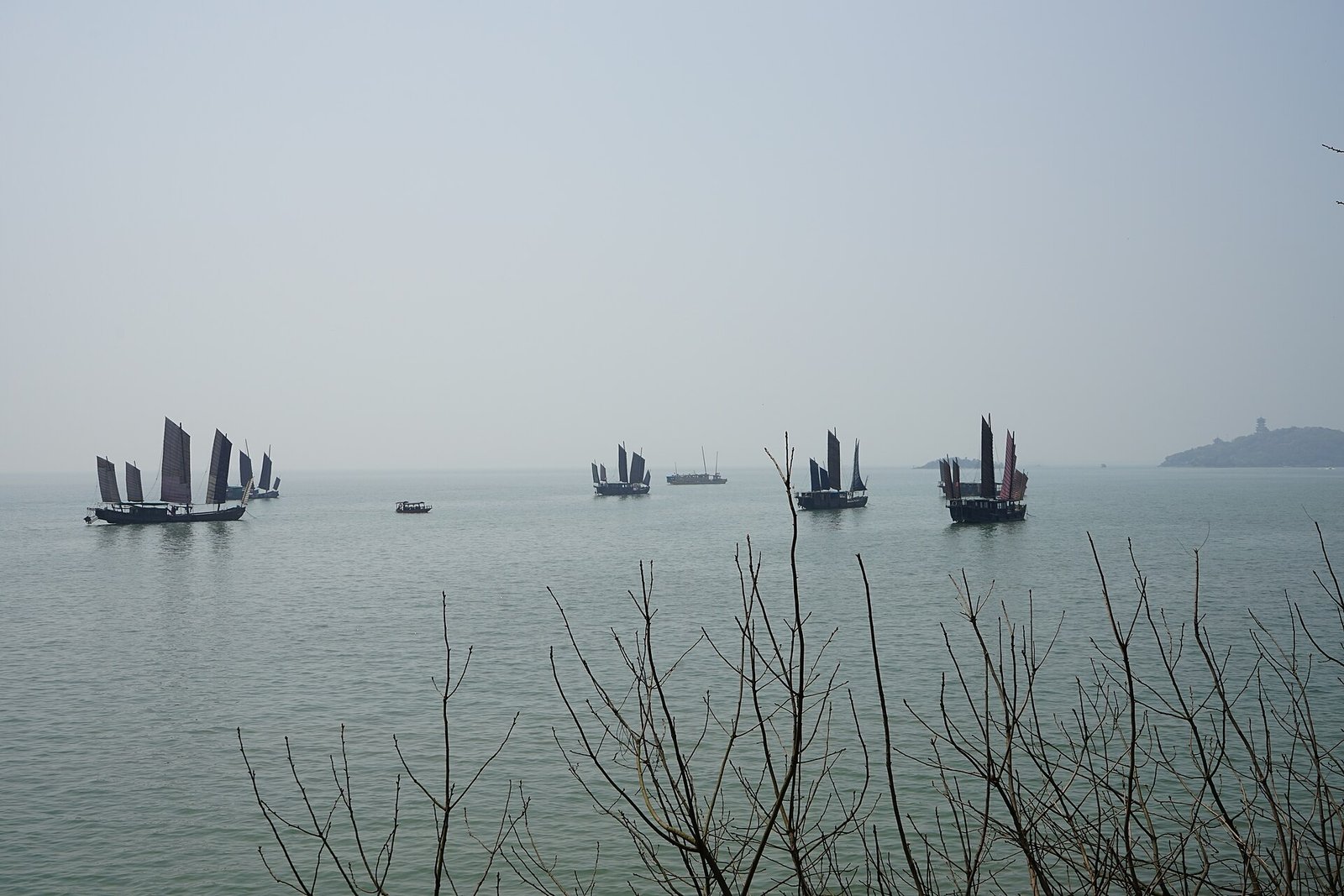 Traditional sailing boats on the misty water of Lake Tai off Yuantouzhu in Wuxi