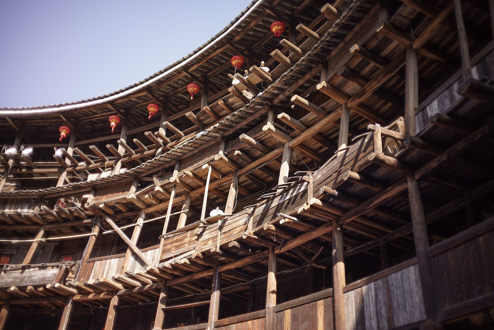 The interior timber frame of Yuchang Lou, with visibly leaning columns and stacked galleries around a courtyard
