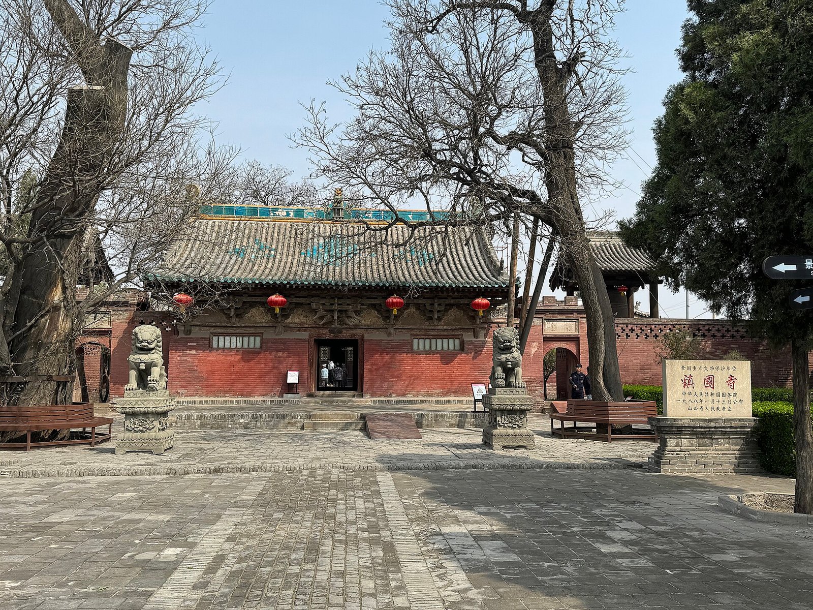 A weathered timber temple hall with deep eaves at Zhenguo Temple outside Pingyao